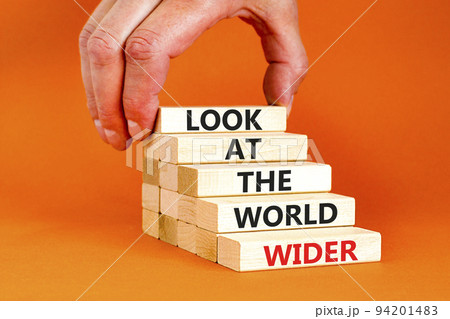 Look at the world wider symbol. Concept words Look at the world wider on wooden blocks on a beautiful orange background. Businessman hand. Business and look at the world wider concept. Copy space. Look at the world wider symbol. Concept words Look at the world wider on wooden blocks on a beautiful orange background. Businessman hand. Business and look at the world wider concept. Copy space. 94201483