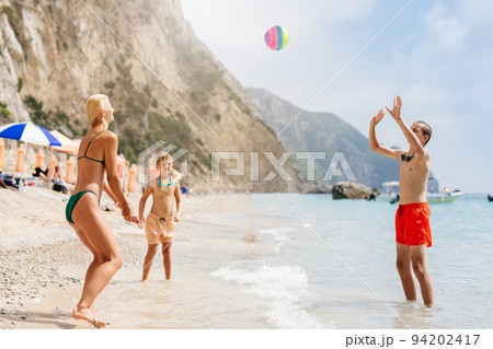 Happy family on the beach in Corfu, Greece 94202417
