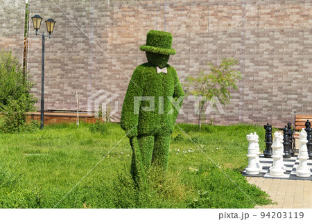 Sculpture made of artificial grass in the city, topiary figure. Selective focus 94203119
