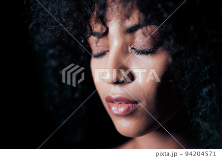 Portrait of afro girl. Tempting woman with perfect makeup and curly hairstyle smiling. Glamour Portrait of afro girl. Tempting woman with perfect makeup and curly hairstyle smiling. Glamour 94204571