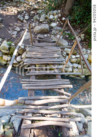 city ruins Olimpos bridge through a stream 94205058