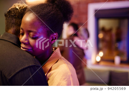 Happy young woman embracing her girlfriend during romantic slow dance 94205569