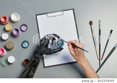 Woman with disability painting on paper 94205649