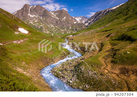 River in idyllic and dramatic landscape of Haute Savoie in Vanoise, France 94207304