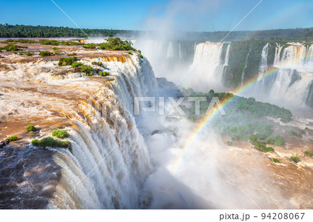 Iguazu Falls dramatic landscape with rainbow, view from Argentina side 94208067