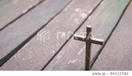 Cross with wood plank background. 94212582