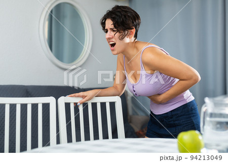 Young woman holding hands on the illness stomache Young woman holding hands on the illness stomache 94213049