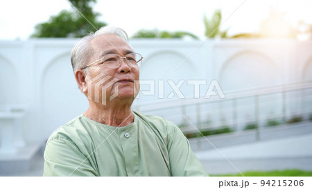 Happy - cheerful Asian elder adult age between 70-80 years old relaxing at the park. Mental health care and wellness in elderly people concept. Happy old man standing at the park and smiling. Happy - cheerful Asian elder adult age between 70-80 years old relaxing at the park. Mental health care and wellness in elderly people concept. Happy old man standing at the park and smiling. 94215206