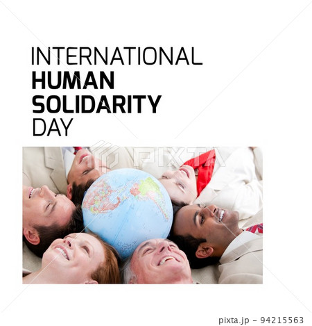 Composite of international human solidarity day text and coworkers lying around globe in office Composite of international human solidarity day text and coworkers lying around globe in office 94215563