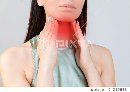 Sore throat in flu season. Young asian woman touching her neck and feeling pain in throat in the bedroom at home. Sore throat in flu season. Young asian woman touching her neck and feeling pain in throat in the bedroom at home. 94216658