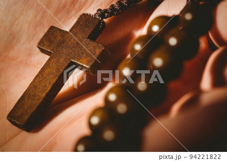 Hand holding rosary beads Hand holding rosary beads 94221822