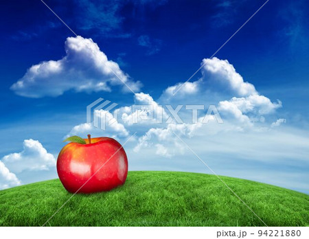Red apple on hill under blue sky 94221880