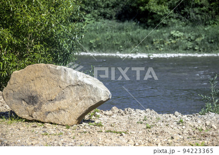 a big stone on rivebank a big stone on rivebank 94223365