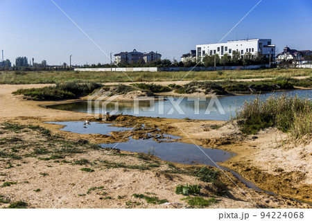 a shallow salty lagoon near the Azov Sea on the Arabat Spit, Ukraine a shallow salty lagoon near the Azov Sea on the Arabat Spit, Ukraine 94224068