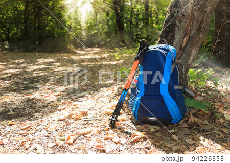 backpack and trekking poles 94226353