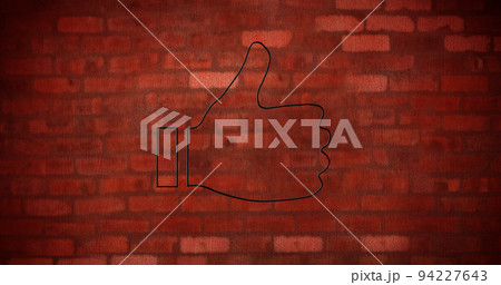 Image of glowing neon thumb up icon on brick wall 94227643