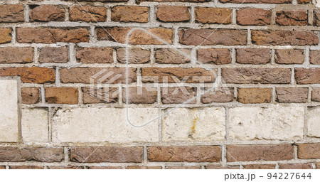 Image of glowing neon arrow icon on brick wall 94227644