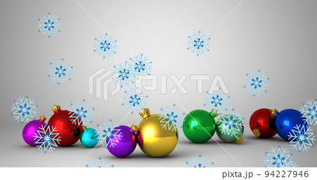 Image of snow falling over christmas baubles Image of snow falling over christmas baubles 94227946