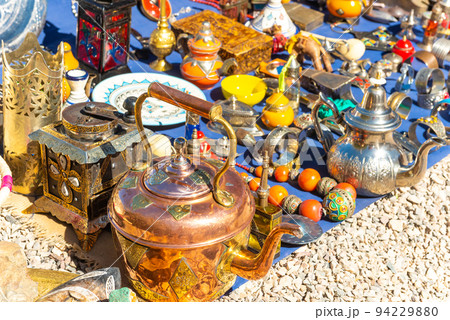 Multicolored Moroccan craft souvenirs at the market. Teapots and plates , decorations, tagines,, trinkets Multicolored Moroccan craft souvenirs at the market. Teapots and plates , decorations, tagines,, trinkets 94229880