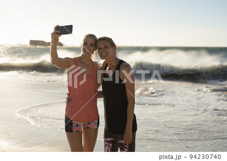 Women taking selfie on the beach Women taking selfie on the beach 94230740
