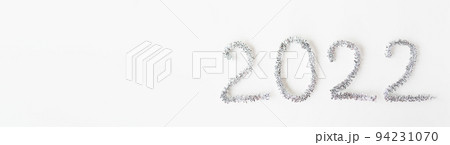 Baner happy new year 2022 written with foil and new year rain on an isolated white background. Happy new year greetings. 94231070