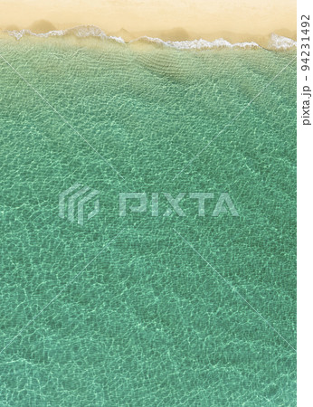 Overhead view of turquoise ocean and beach Overhead view of turquoise ocean and beach 94231492