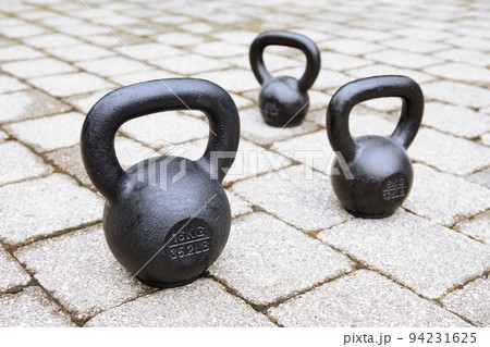 Kettlebells on sidewalk 94231625