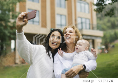Grandmothers taking selfie with baby grandson (6-11 months) Grandmothers taking selfie with baby grandson (6-11 months) 94231781