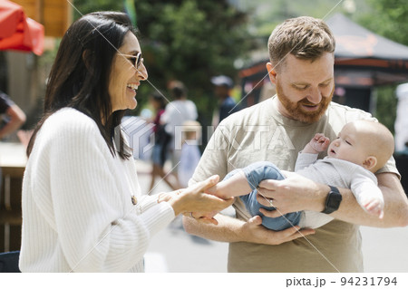 Smiling woman with son and grandson (6-7 months) 94231794