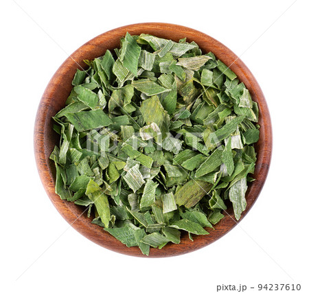 Dry chopped spring onion in wooden bowl, isolated on white background. Dried green onion or scallion. Spices and herbs. Top view. Dry chopped spring onion in wooden bowl, isolated on white background. Dried green onion or scallion. Spices and herbs. Top view. 94237610