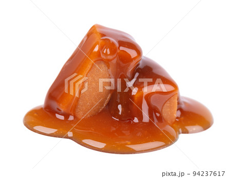 Sweet caramel candies and sauce, isolated on white background. Delicious caramel. Sweet caramel candies and sauce, isolated on white background. Delicious caramel. 94237617