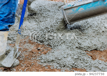 Worker pour pouring concrete parking for car Worker pour pouring concrete parking for car 94237730