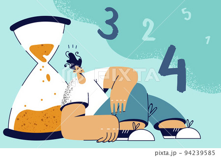 Tired man near sandglass  94239585