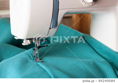 Modern sewing machine and turquoise fabric Modern sewing machine and turquoise fabric 94240084
