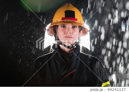 Portrait of a female firefighter standing and walking brave and optimistic. Portrait of a female firefighter standing and walking brave and optimistic. 94241137