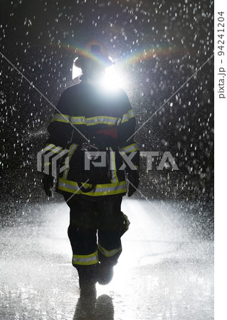 Portrait of a female firefighter standing and walking brave and optimistic. Portrait of a female firefighter standing and walking brave and optimistic. 94241204