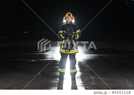 Portrait of a female firefighter standing and walking brave and optimistic. 94241228
