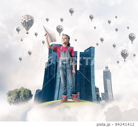 Concept of careless happy childhood with girl dreaming about future Concept of careless happy childhood with girl dreaming about future 94241412