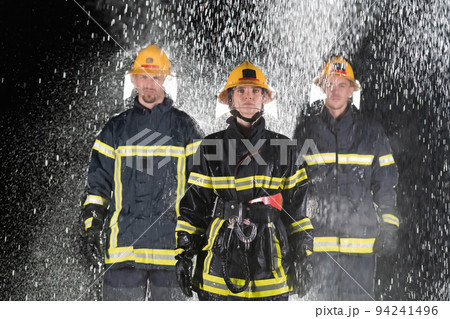 Portrait of a group of firefighters standing and walking brave and optimistic with a female as team leader. Portrait of a group of firefighters standing and walking brave and optimistic with a female as team leader. 94241496