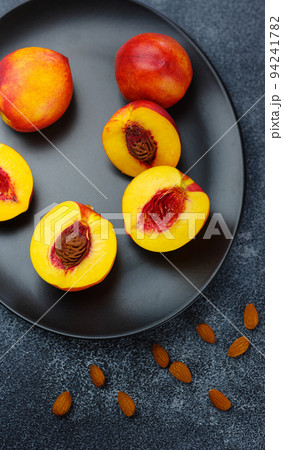 fresh sweet peaches on dark table 94241782