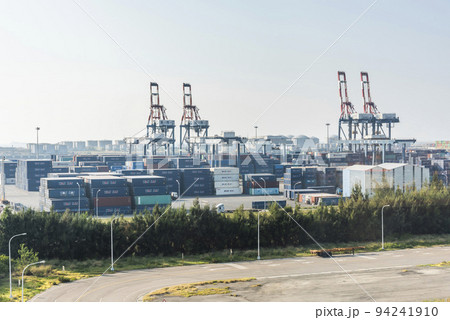 Look over Containers and cranes along the coast of Taichung Port in Taiwan. It is the second-largest port in Taiwan after Kaohsiung Port. 94241910
