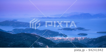 Mountains, islands and city on the sea cost at night 94241942