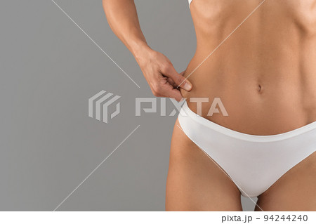 Fat Burning. Closeup Shot Of Female Pinching Skin On Her Waist Side 94244240