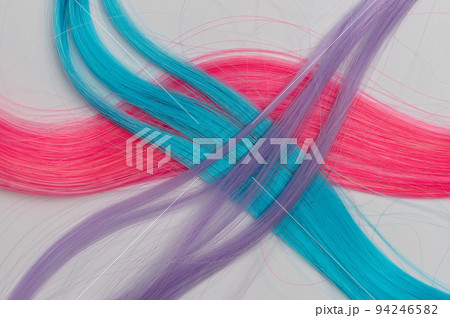 Crossed colorful hair strands Crossed colorful hair strands 94246582