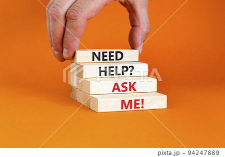 Support and need help ask me symbol. Concept words Need help ask me on wooden blocks on a beautiful orange table orange background. Businessman hand. Business, support and Need help ask me concept. 94247889