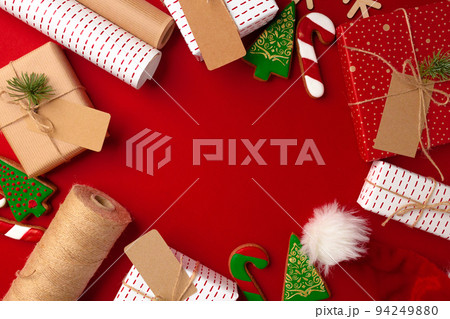 Christmas preparations concept with wrapping paper, gift boxes on red background 94249880