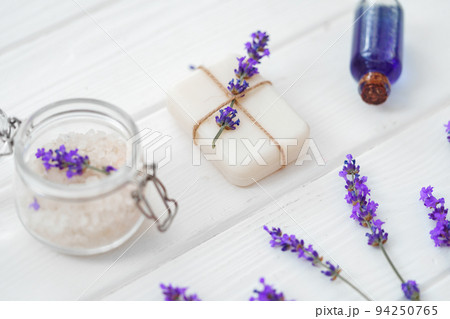 Lavender soap bars and spa products with lavender flowers on a white wooden table 94250765