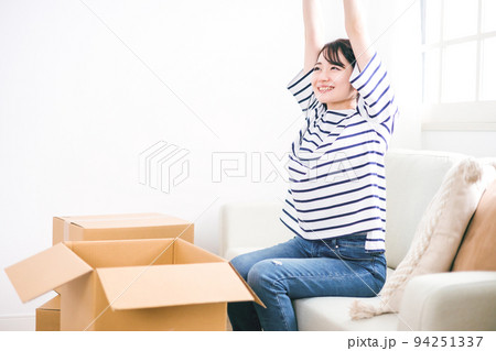 引越し作業中に笑顔で休憩する女性 引越し作業中に笑顔で休憩する女性 94251337