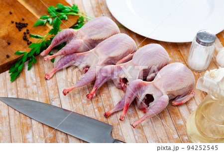 Fresh raw meat quails ready for cooking on slate board 94252545