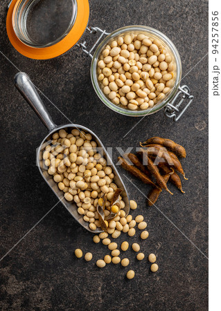 Soy beans. Dried soybean pod in scoop on black table. Soy beans. Dried soybean pod in scoop on black table. 94257856
